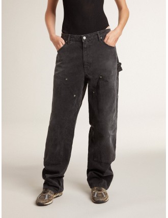 Jeans da donna in cotone di colore nero con effetto distressed con patch frontali